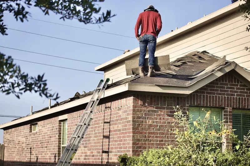 Professional roofer working on a residential roof in The Acre